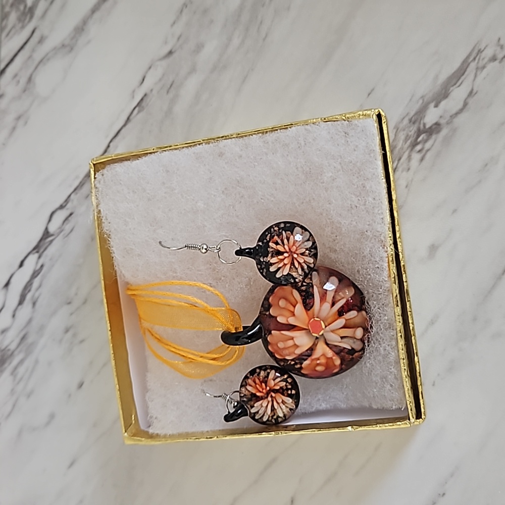 Glass necklace and matching earrings on ribbon
